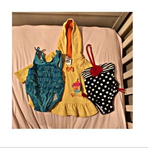 2 baby swimsuits and 1 swimsuit cover up